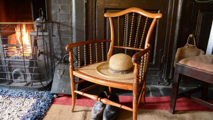 Beatrix Potter's chair next to the fire in the house at Hill Top, Cumbria